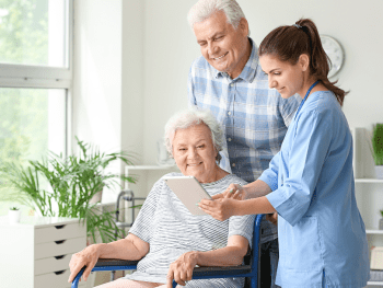 Nurse talking with couple in home, Pemi-Baker Hospice & Home Health, Plymouth, NH